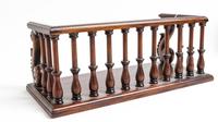 A Mahogany Gallery Height 6 3/8 x width 16 5/8 x depth 7 5/8 inches.