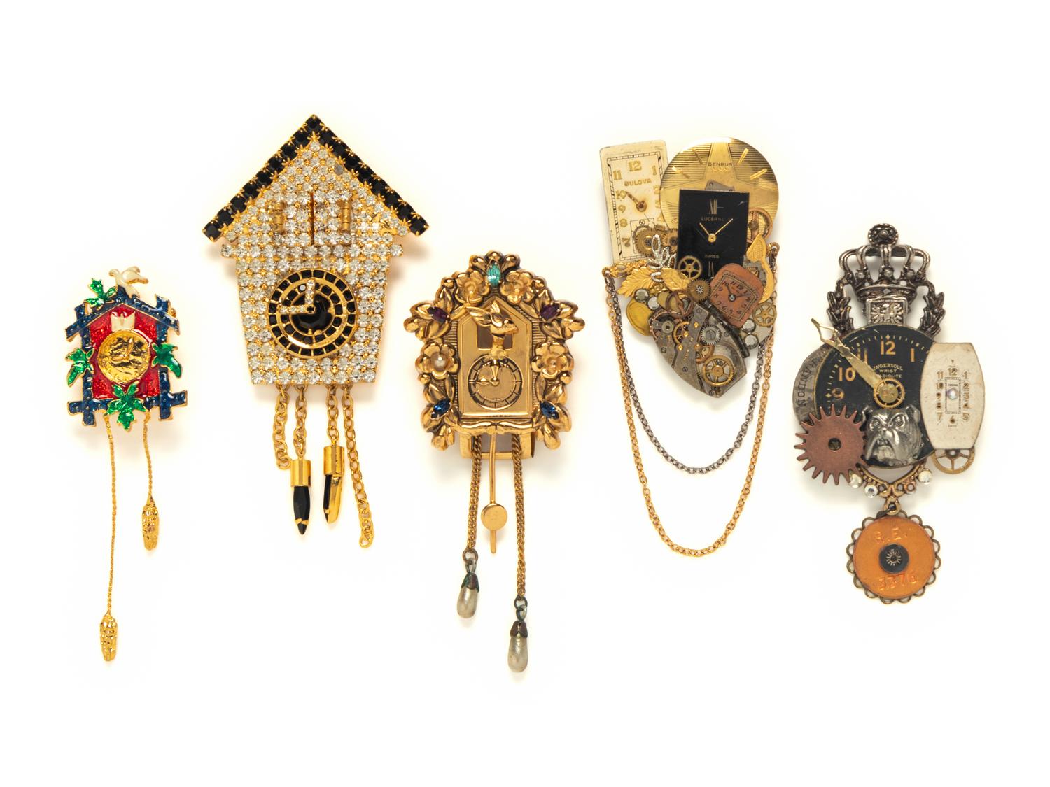 A GROUP OF FIVE TIMEPIECE THEMED BROOCHES