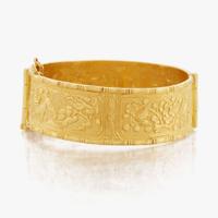 A gold bangle bracelet