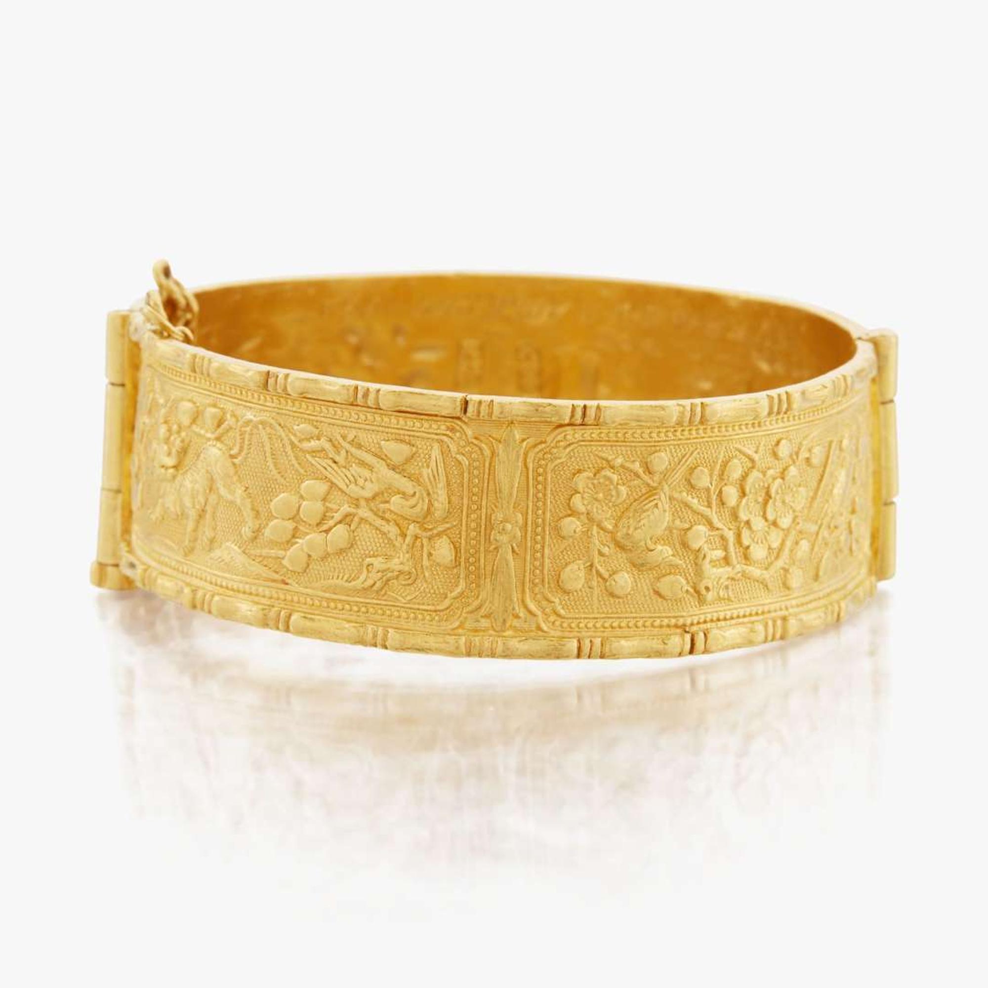 A gold bangle bracelet