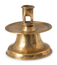 A Continental Punched Brass Capstan Candlestick
