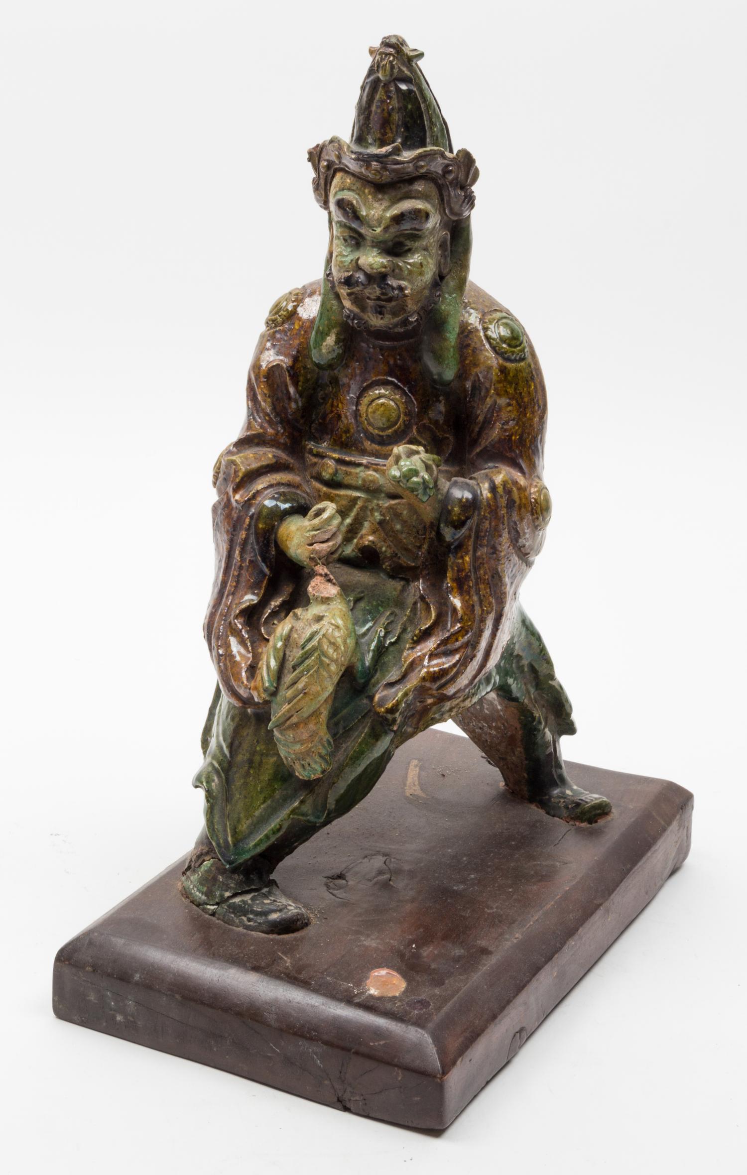 A Sancai Pottery Figural Roof Tile Height 14 inches.