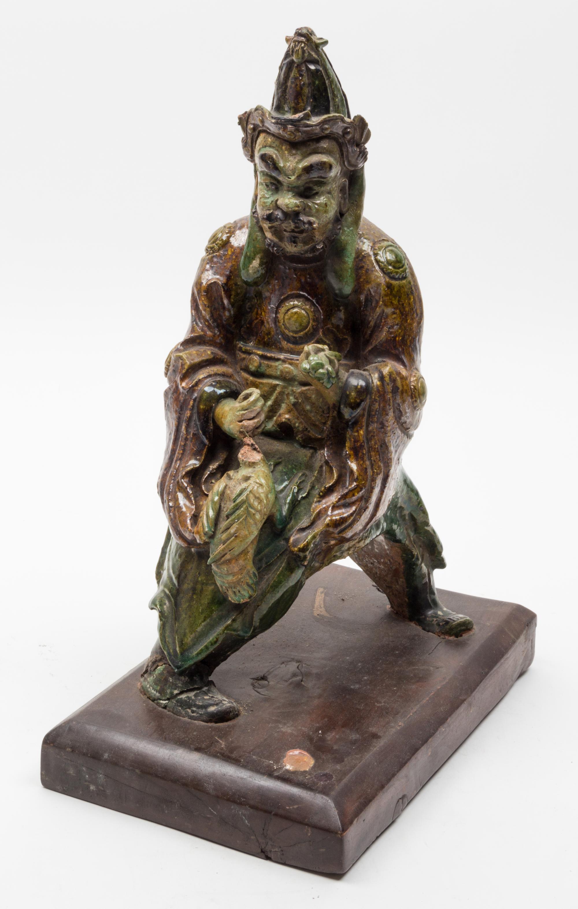 A Sancai Pottery Figural Roof Tile Height 14 inches.