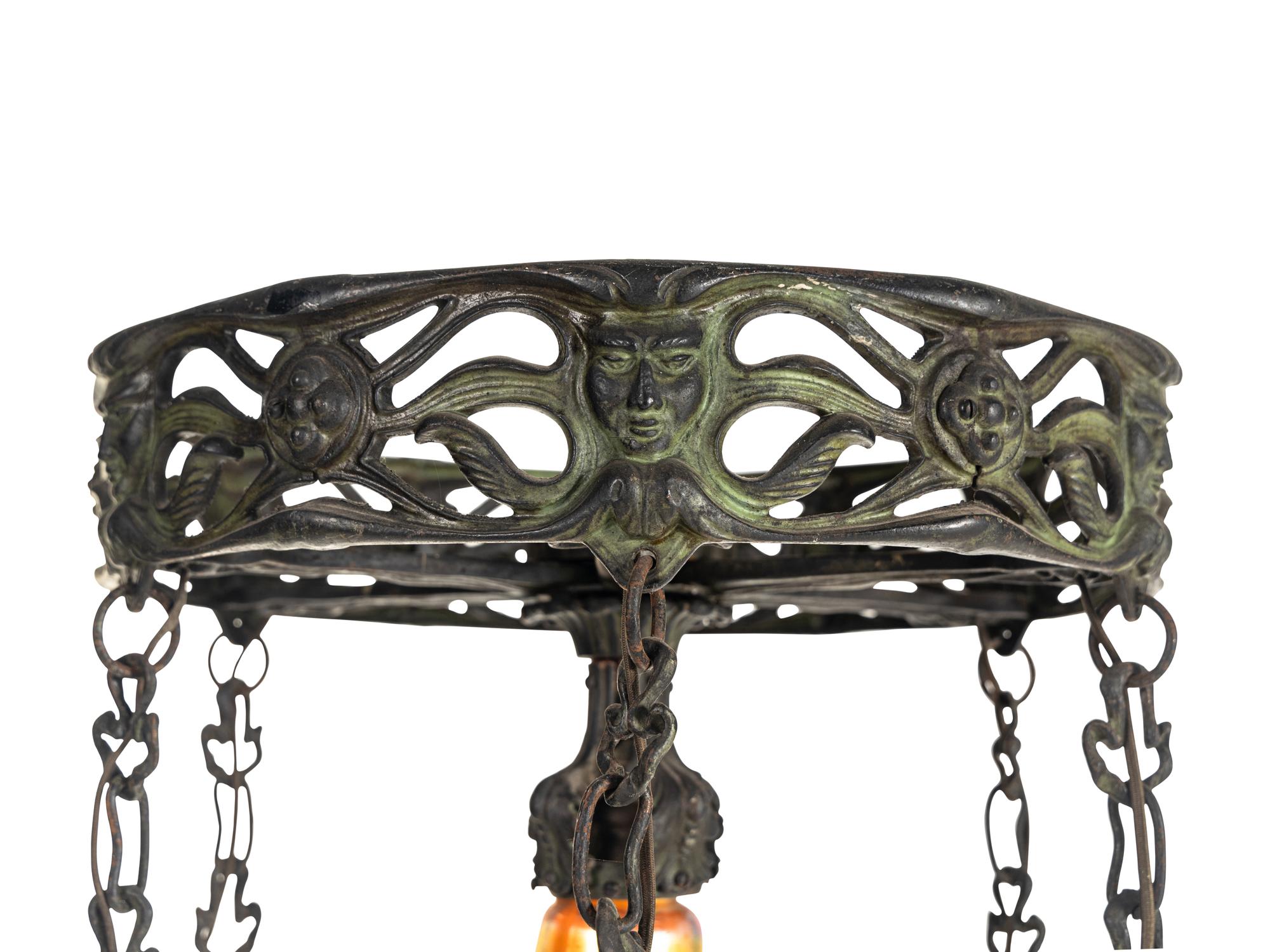 An Art Nouveau Patinated Bronze and Steuben Aurene Glass Seven-Light Ceiling Fixture