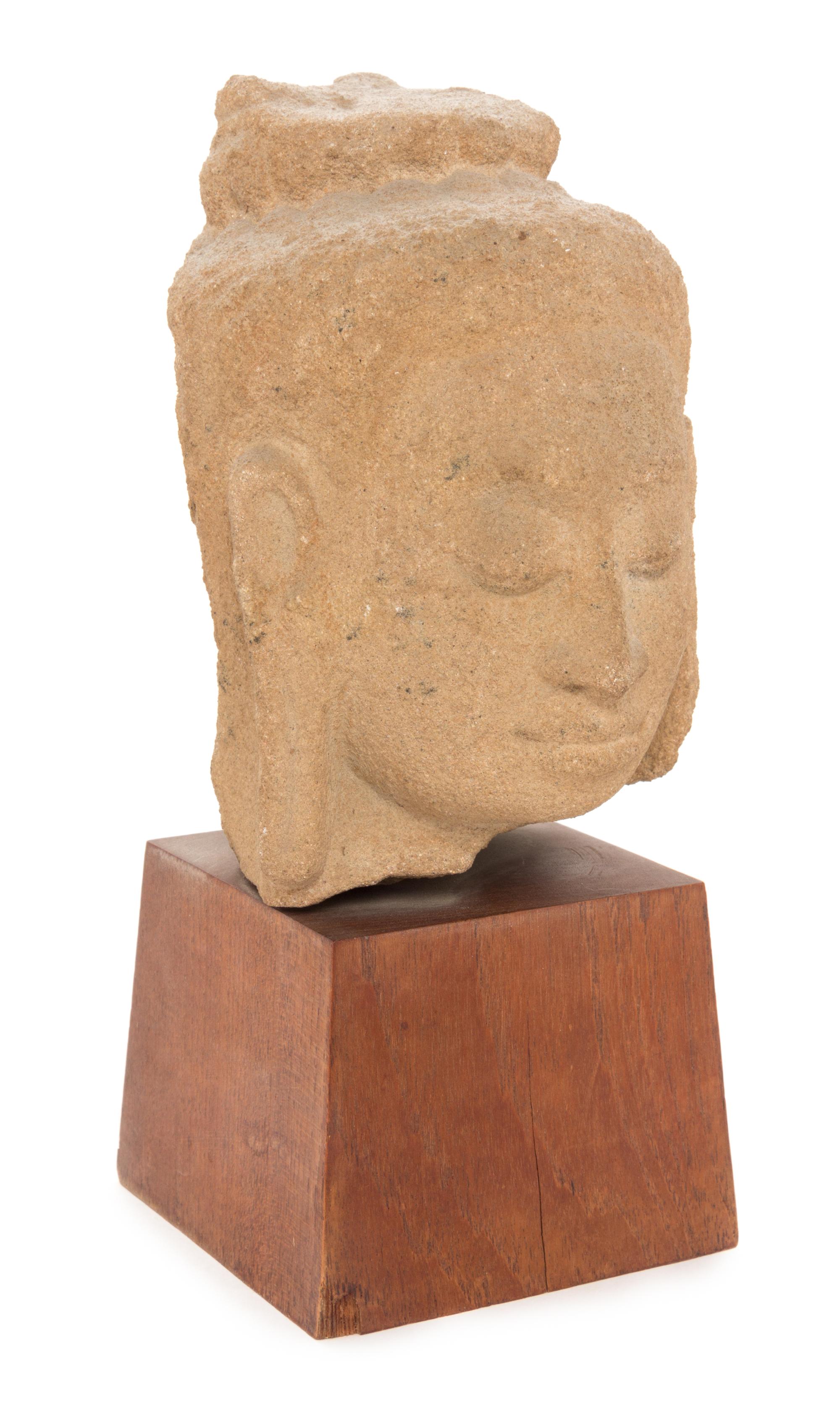 A Thai Stone Head of a Deity Height 6 1/4 inches.