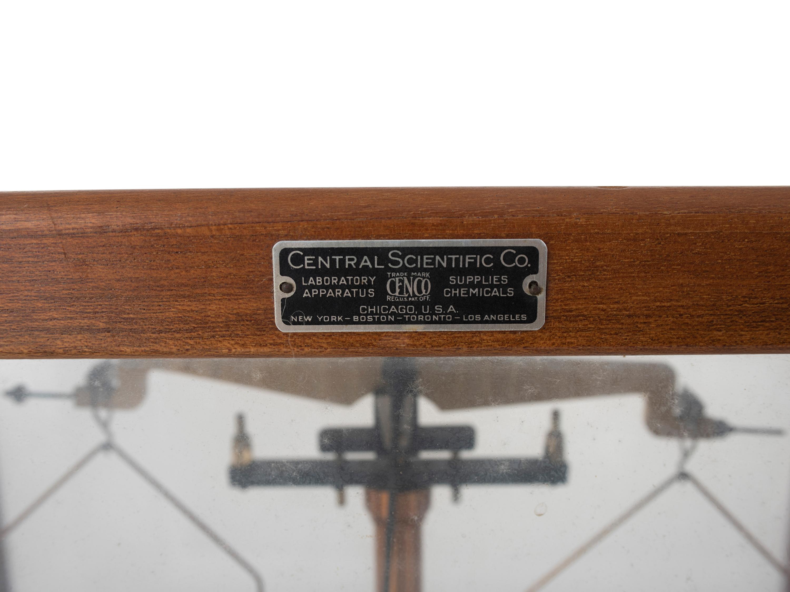 A Central Scientific Co. Scale, an Ingraham Eight-Day Movement Mantle Clock and Framed Salesmen Samples of Blue Grass Axes