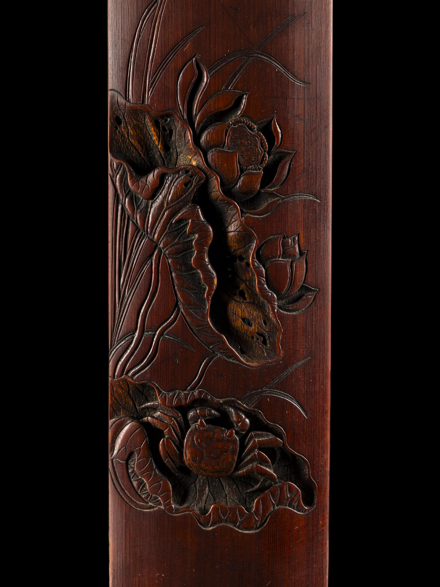 A Chinese Carved Bamboo 'Lotus and Crab' Wrist Rest