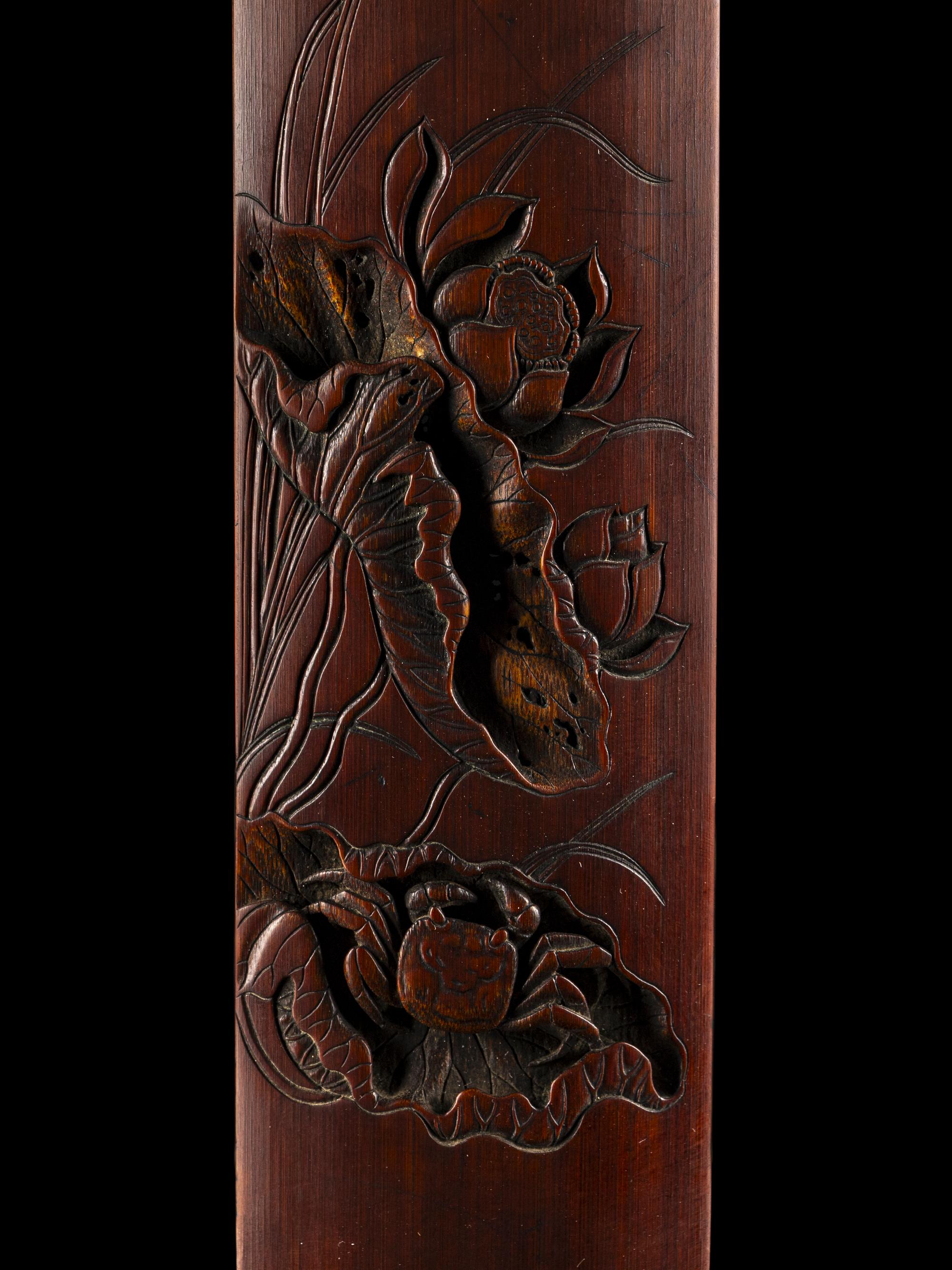 A Chinese Carved Bamboo 'Lotus and Crab' Wrist Rest