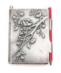 A Continental Silver Chatelaine Notepad, , the case worked to show flowering branches and opening to a partial sheet of stamp-cut paper