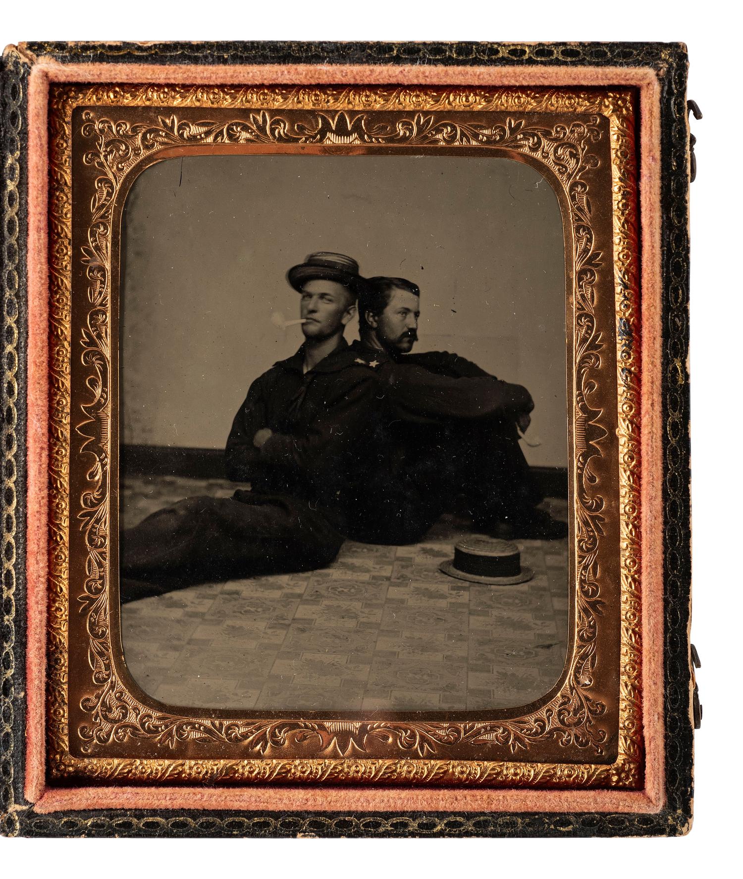 [CIVIL WAR]. Sixth plate tintype of two Union sailors casually sitting back to back on a studio floor.