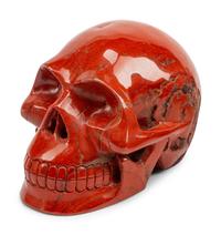 A Set of Four Carved Agate, Fluorite, Red Jasper and Black Obsidian Skulls