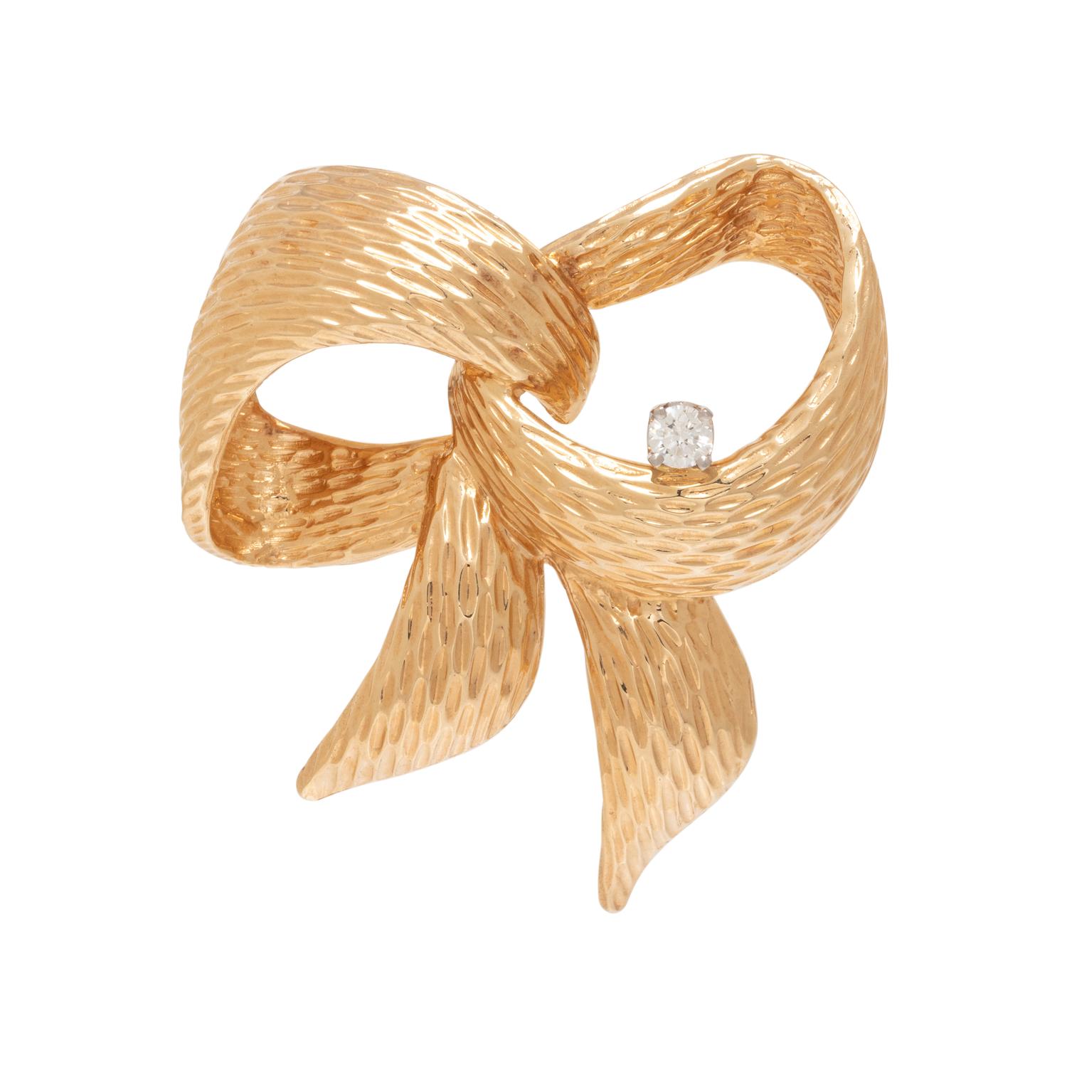 HENRY DANKNER, YELLOW GOLD AND DIAMOND BOW BROOCH