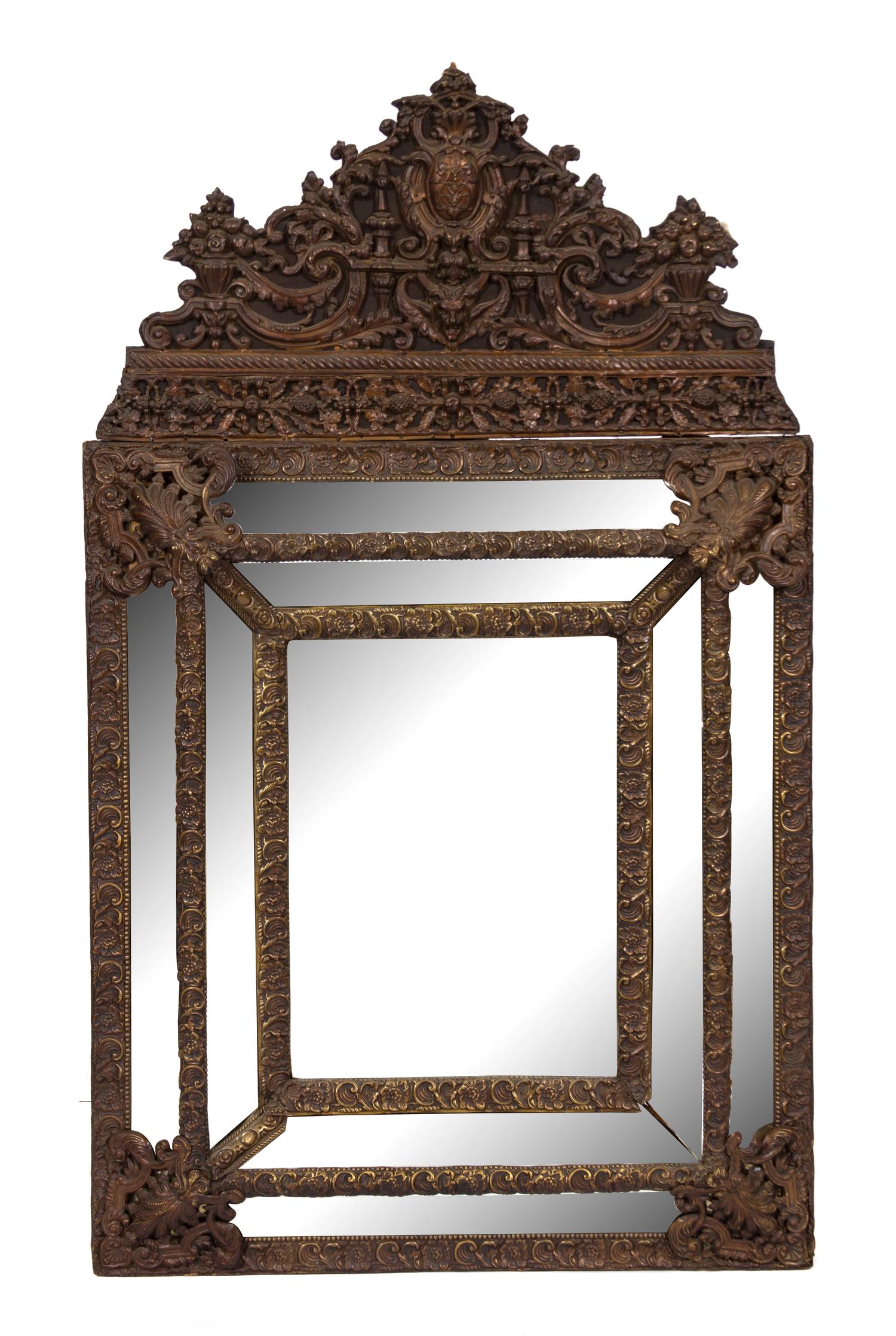 A Dutch Repousse Brass Cushion Mirror Height 51 x width 30 inches. — 19TH CENTURY