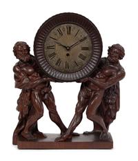A Continental Carved Oak Figural Clock