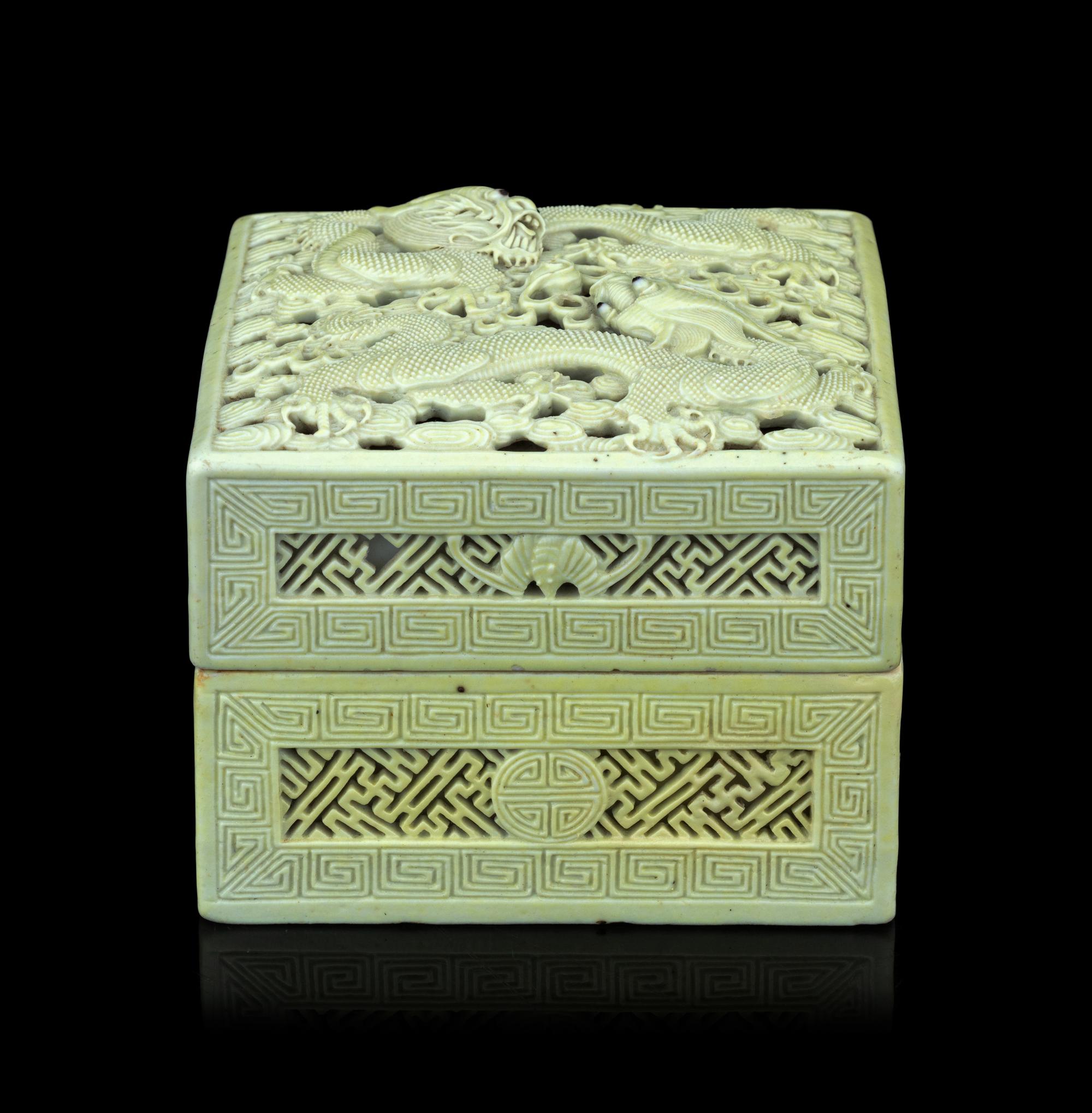 A Carved and Molded Pale Lime Glazed Porcelain 'Dragons' Seal Paste Box and Cover