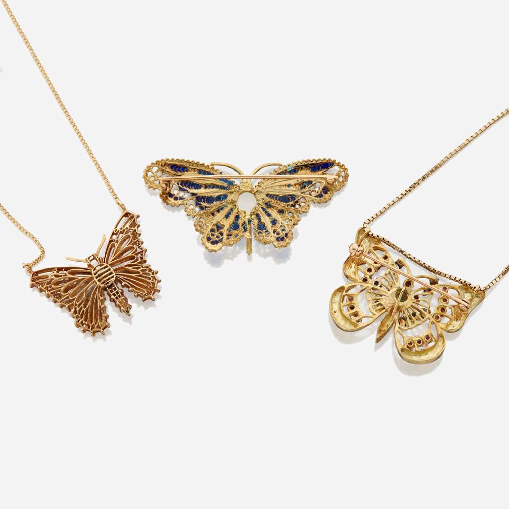 A collection of three pieces of gold and gem set jewelry