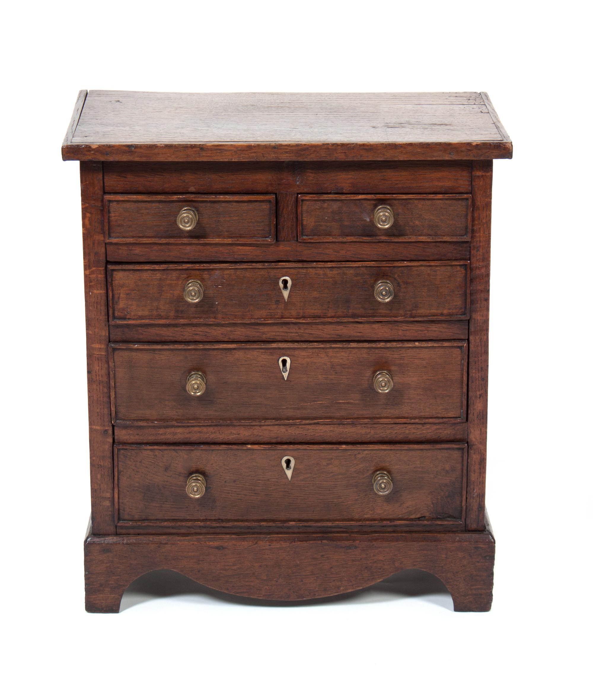 A Small Chest of Drawers Height 18 1/4 inches.