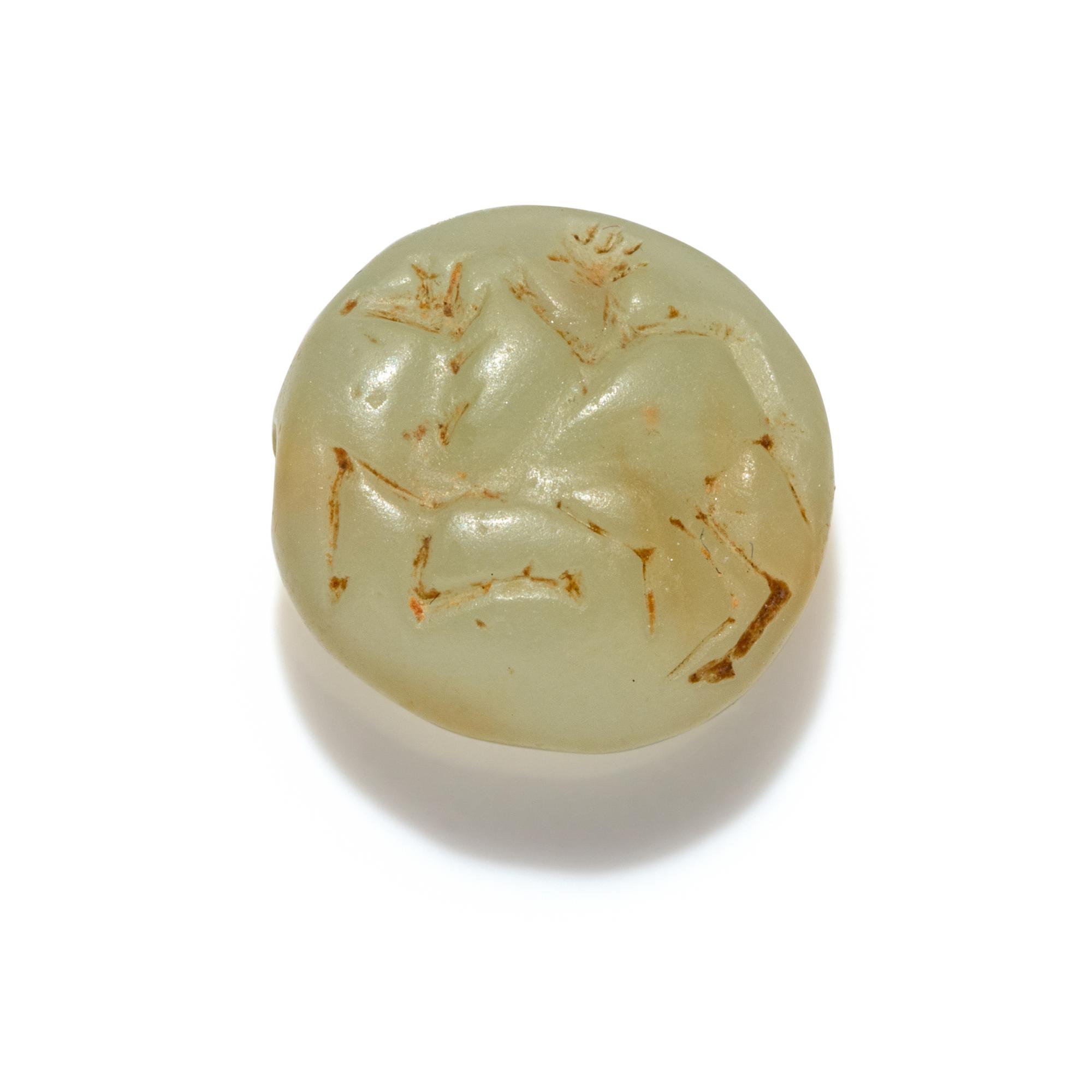 A Minoan Pale Green Steatite Lentoid with a Figure on Horseback
