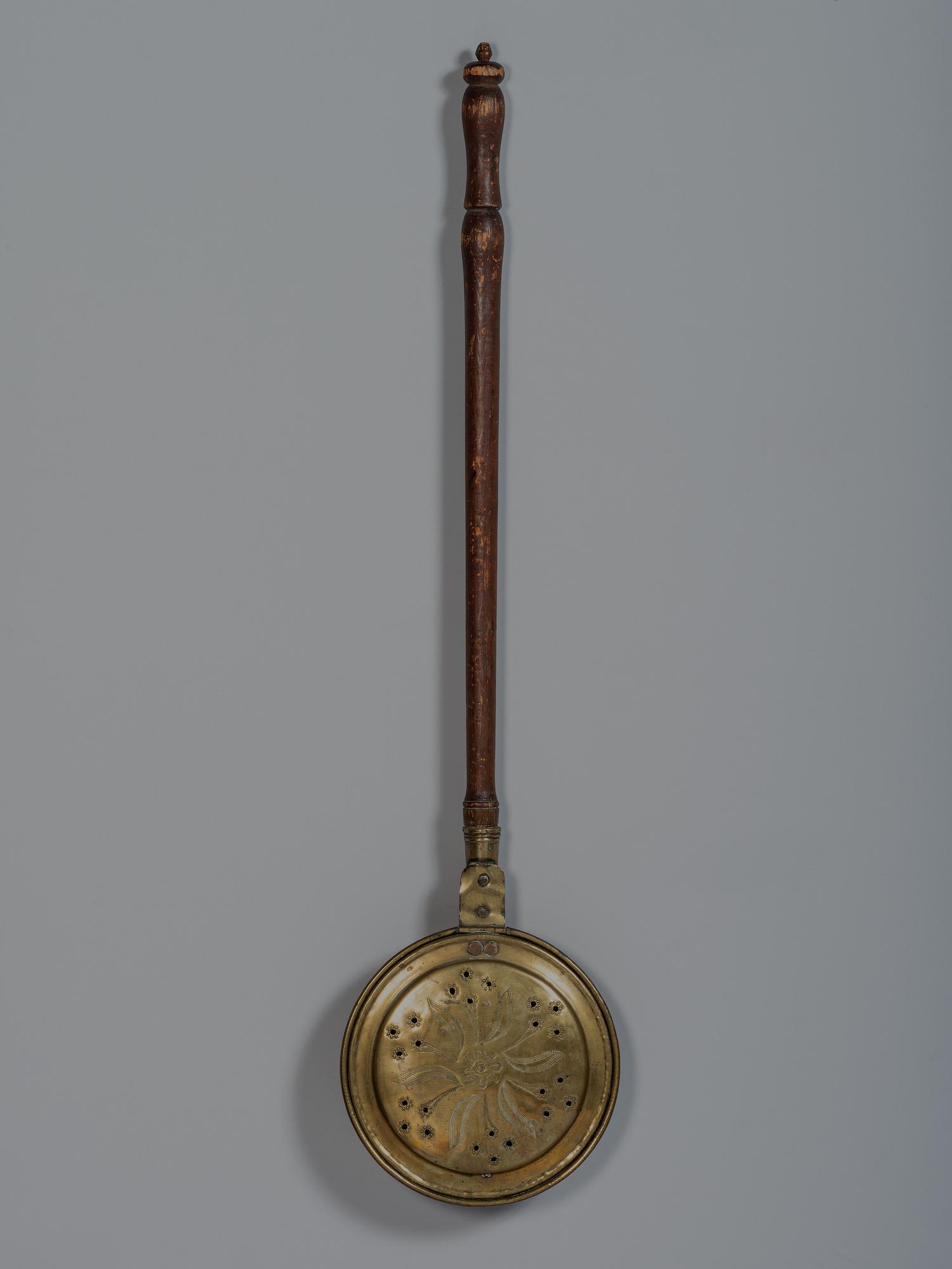 An English Engraved and Pierced Brass Bed Warmer