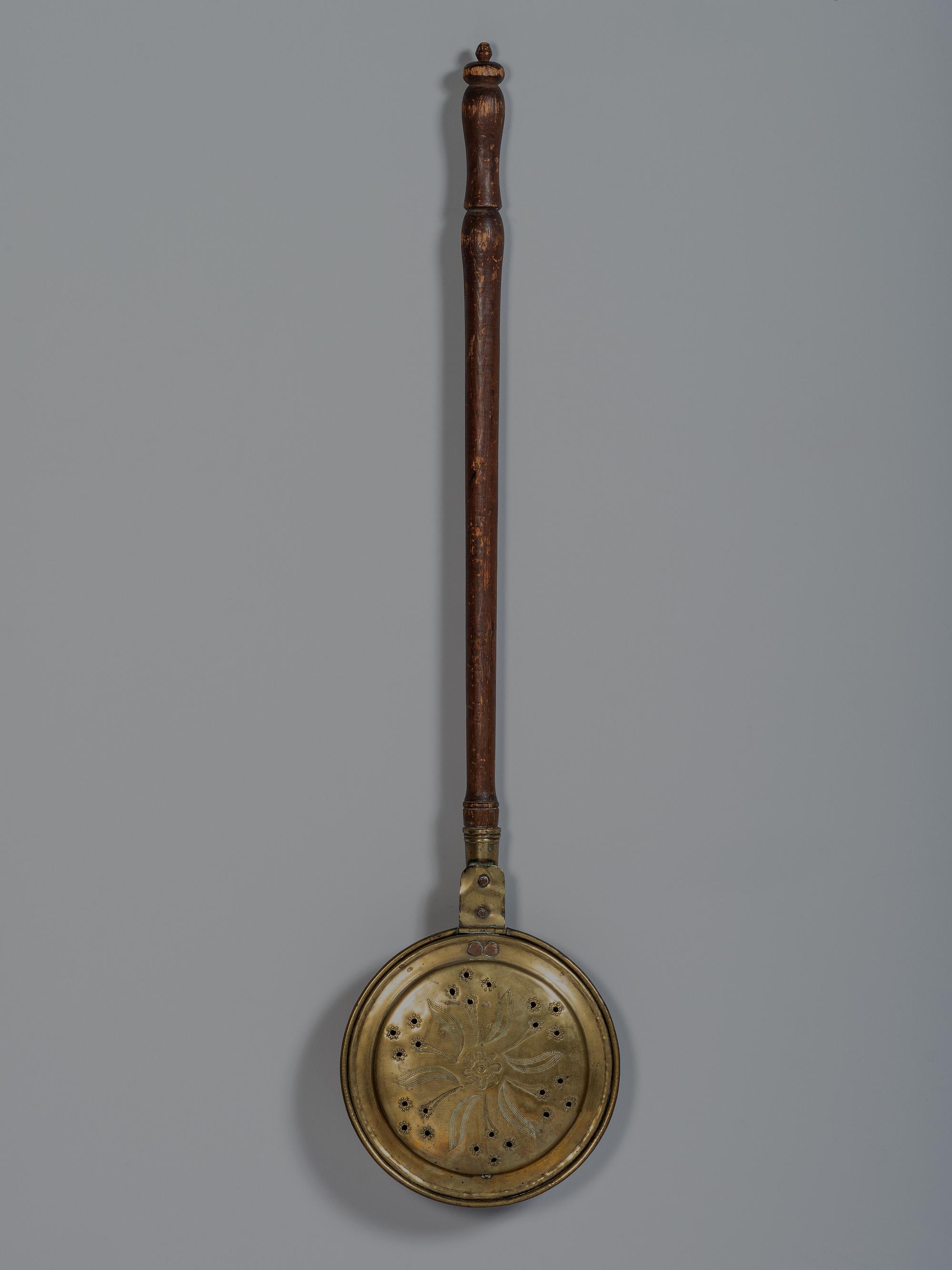 An English Engraved and Pierced Brass Bed Warmer