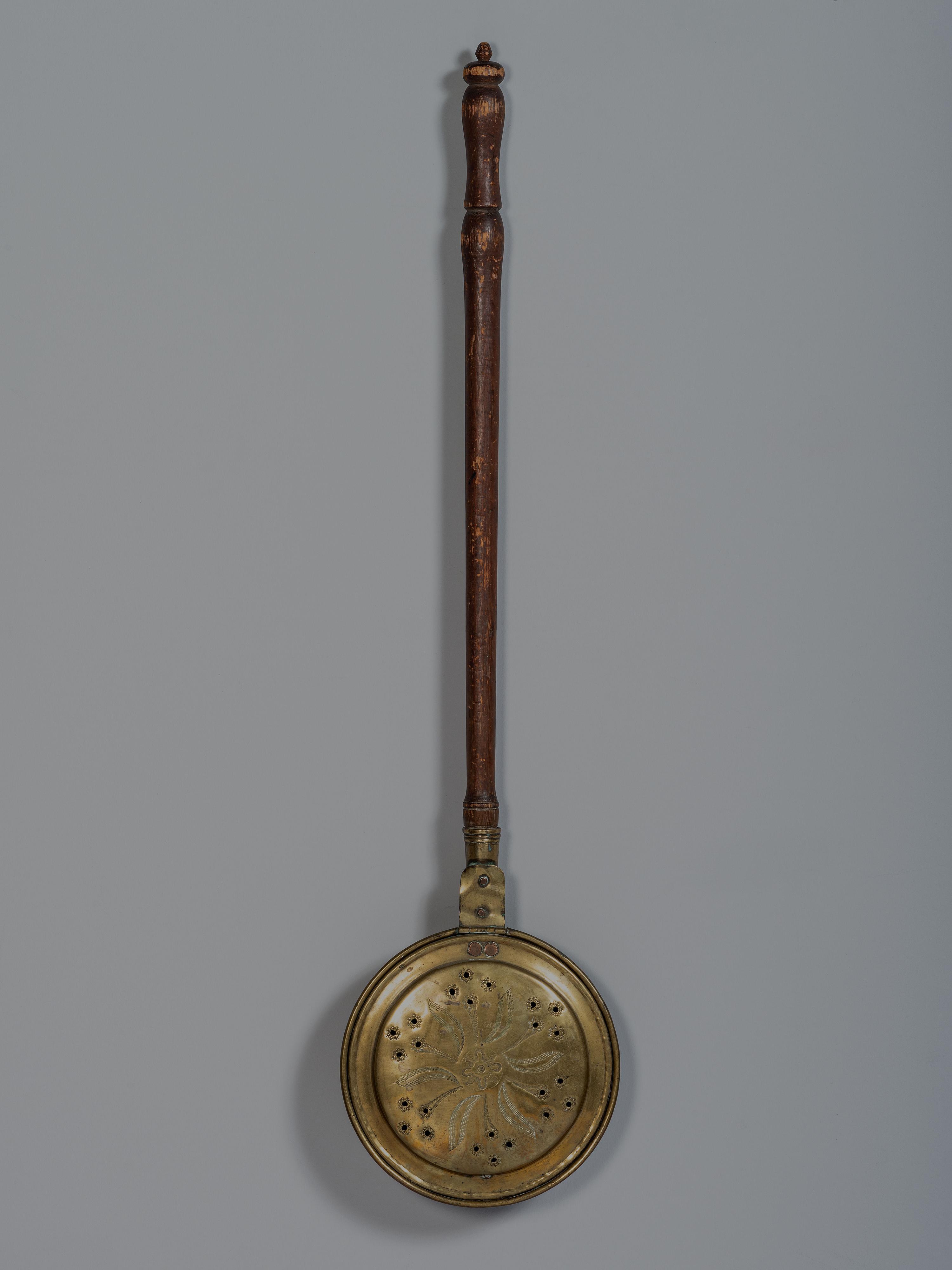 An English Engraved and Pierced Brass Bed Warmer