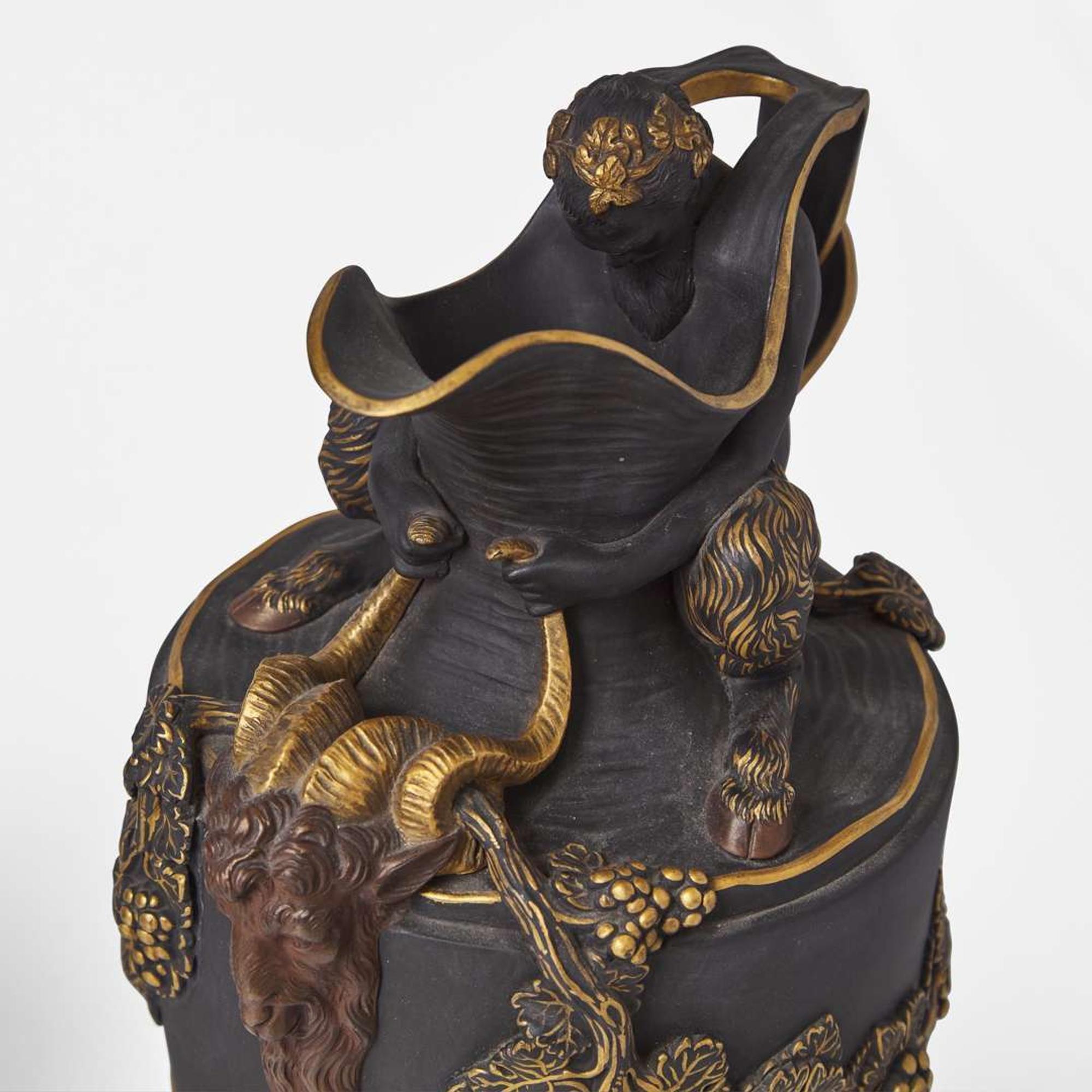 A Near Pair of Wedgwood Gilt and Bronzed Black Basalt Water and Wine Ewers UK, late 19th century