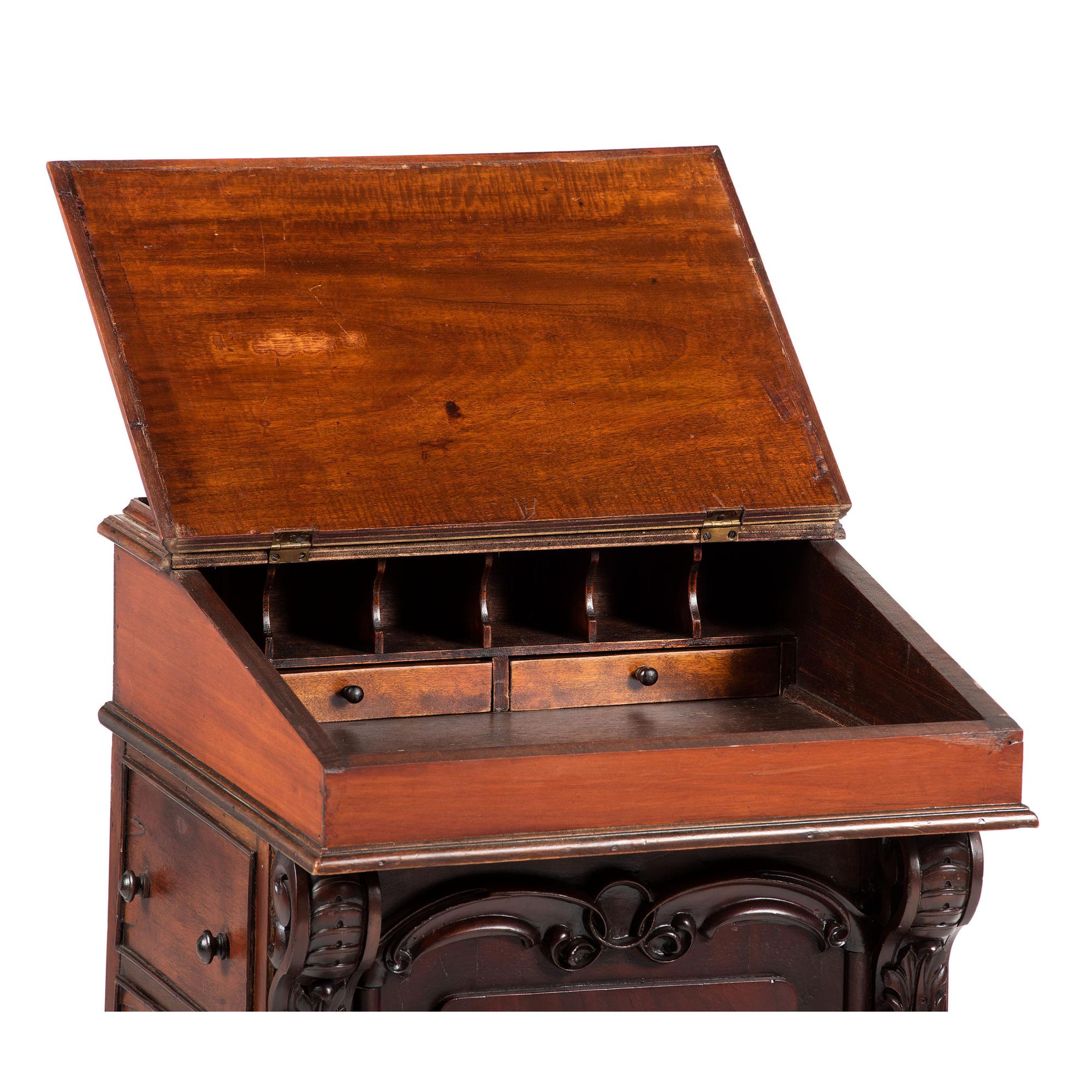 A Victorian Carved Mahogany Davenport Desk