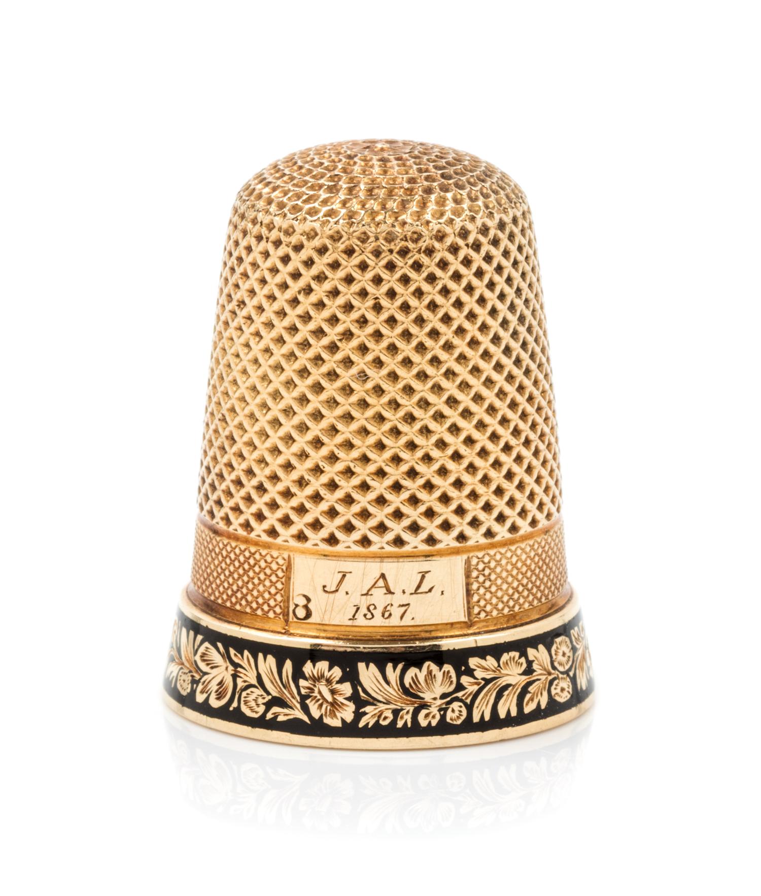 An American Yellow Gold and Enamel Thimble, , the knurled top and body above an engine turned band with an engraved cartouche and a flo