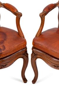 A Pair of Louis XV Beechwood Fauteuils with Cane and Leather Seat Cushions