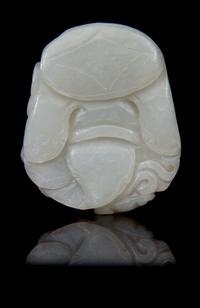 A Carved Jade Toggle Length 2 1/4 inches.