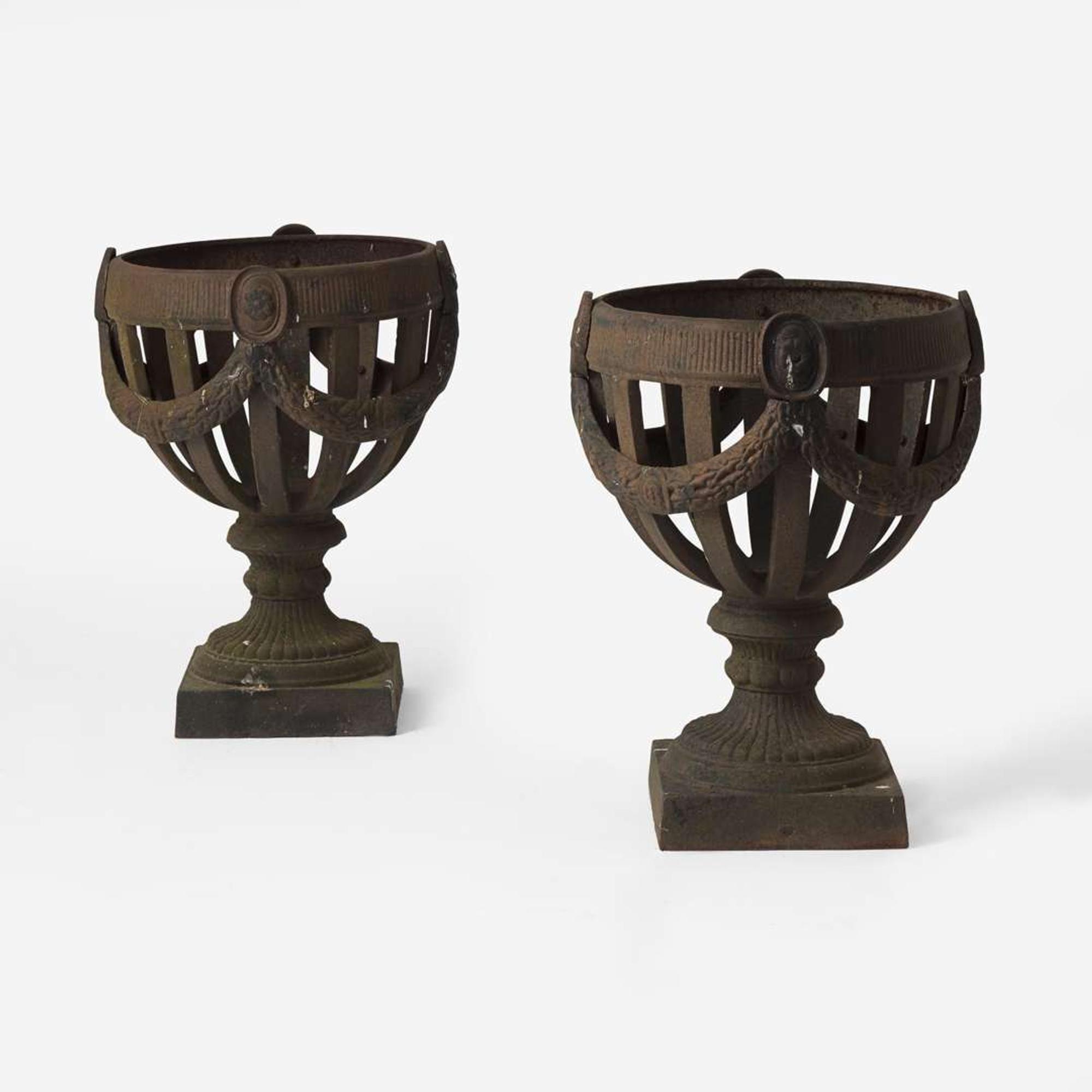 A pair of cast iron open-work garden urns late 19th century