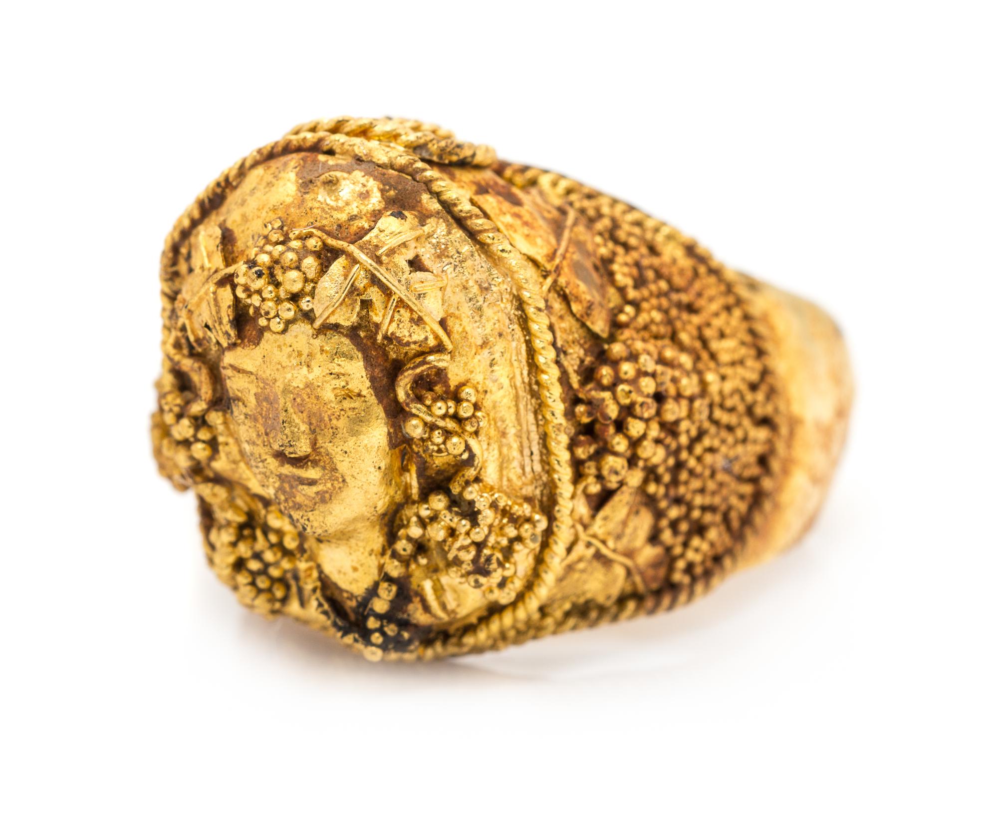A High Karat Yellow Gold Bacchus Motif Ring, 14.20 dwts.