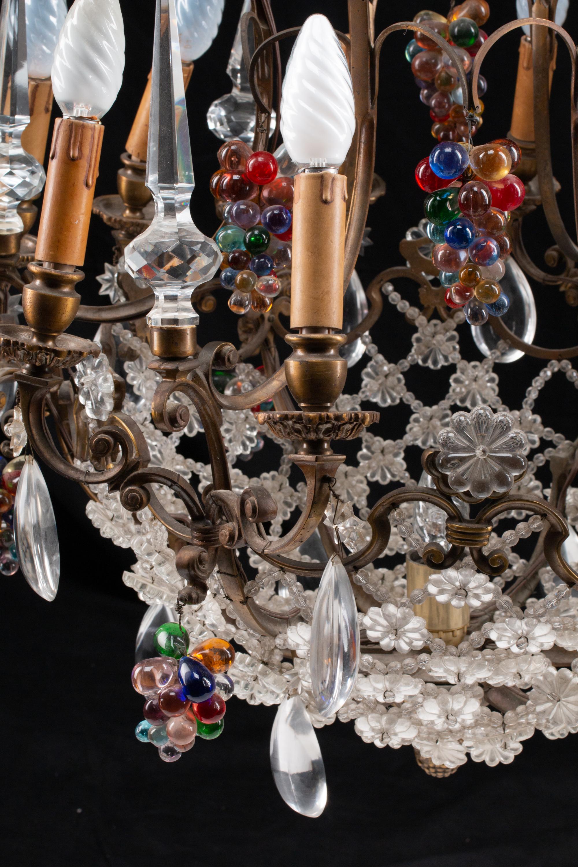 A Louis XV Style Patinated Bronze, Cut and Colored Glass Fourteen-Light Chandelier