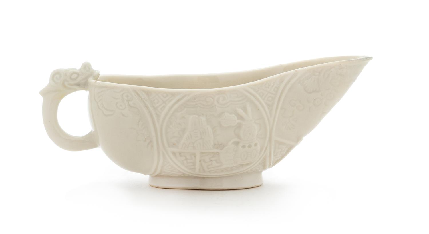 A Chinese Blanc-de-Chine Porcelain Libation Cup Length 5 1/2 inches. — 17TH CENTURY