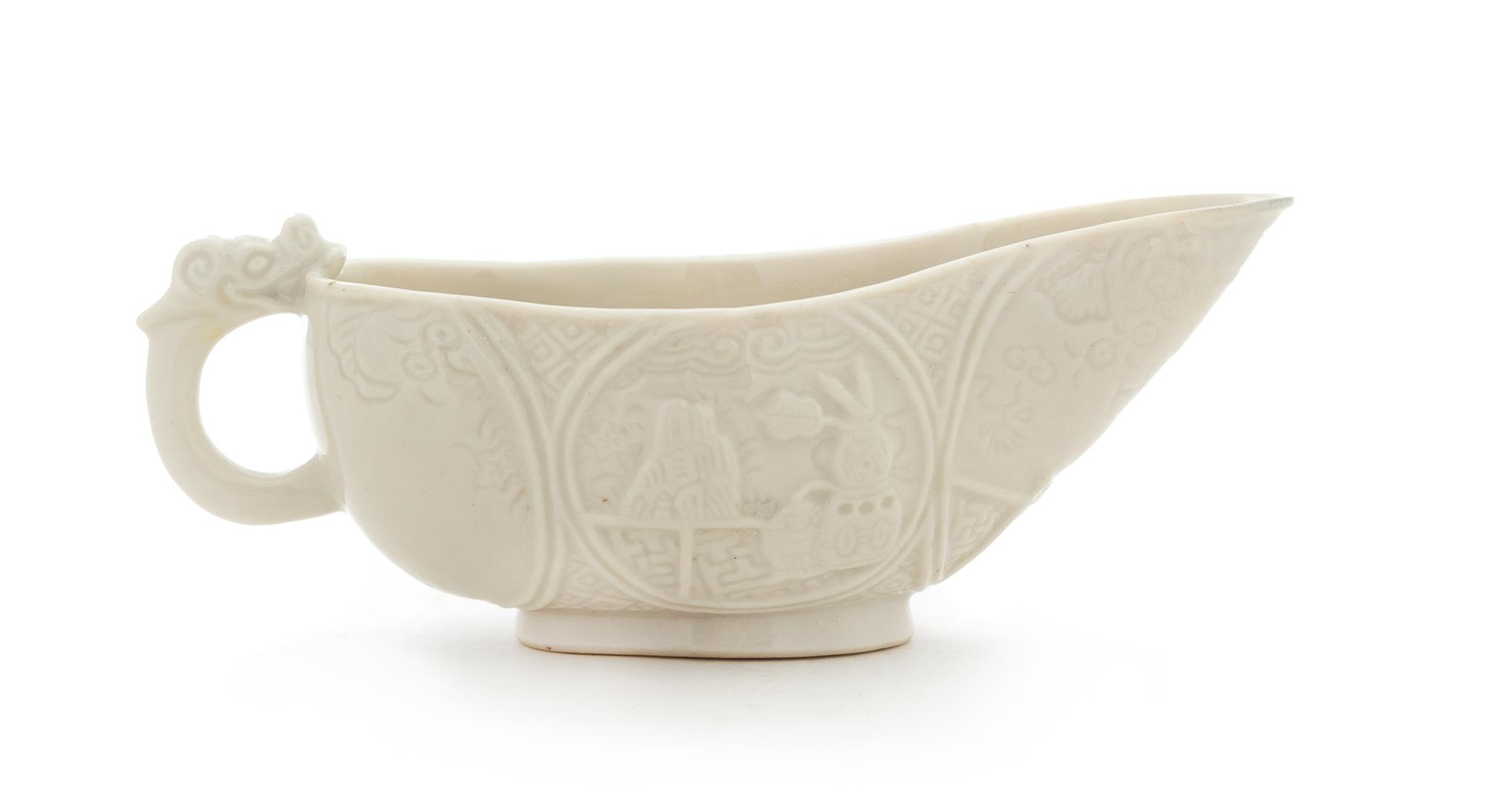 A Chinese Blanc-de-Chine Porcelain Libation Cup Length 5 1/2 inches. — 17TH CENTURY