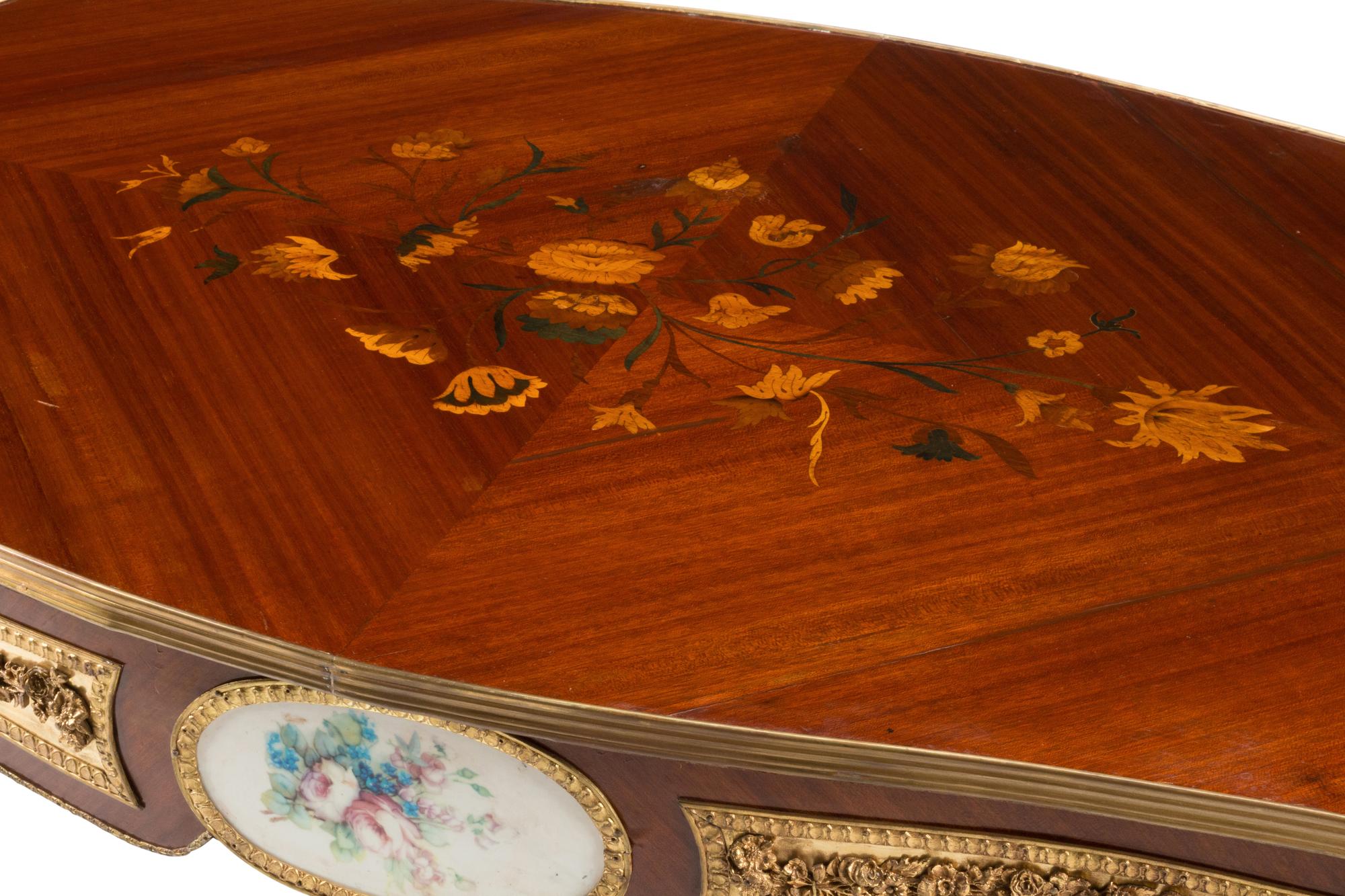 A Louis XV Style Gilt Bronze and Porcelain Mounted Low Table