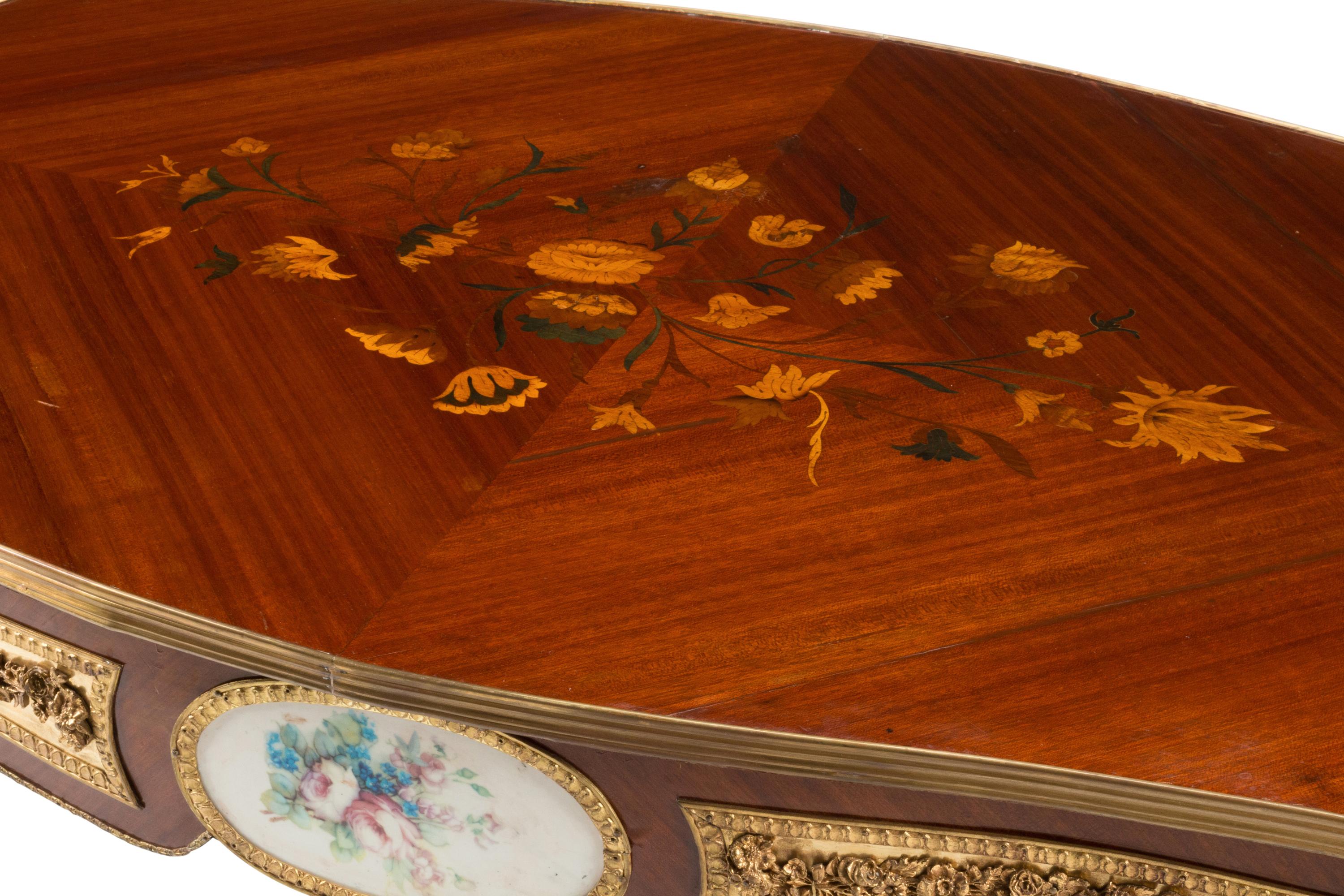 A Louis XV Style Gilt Bronze and Porcelain Mounted Low Table