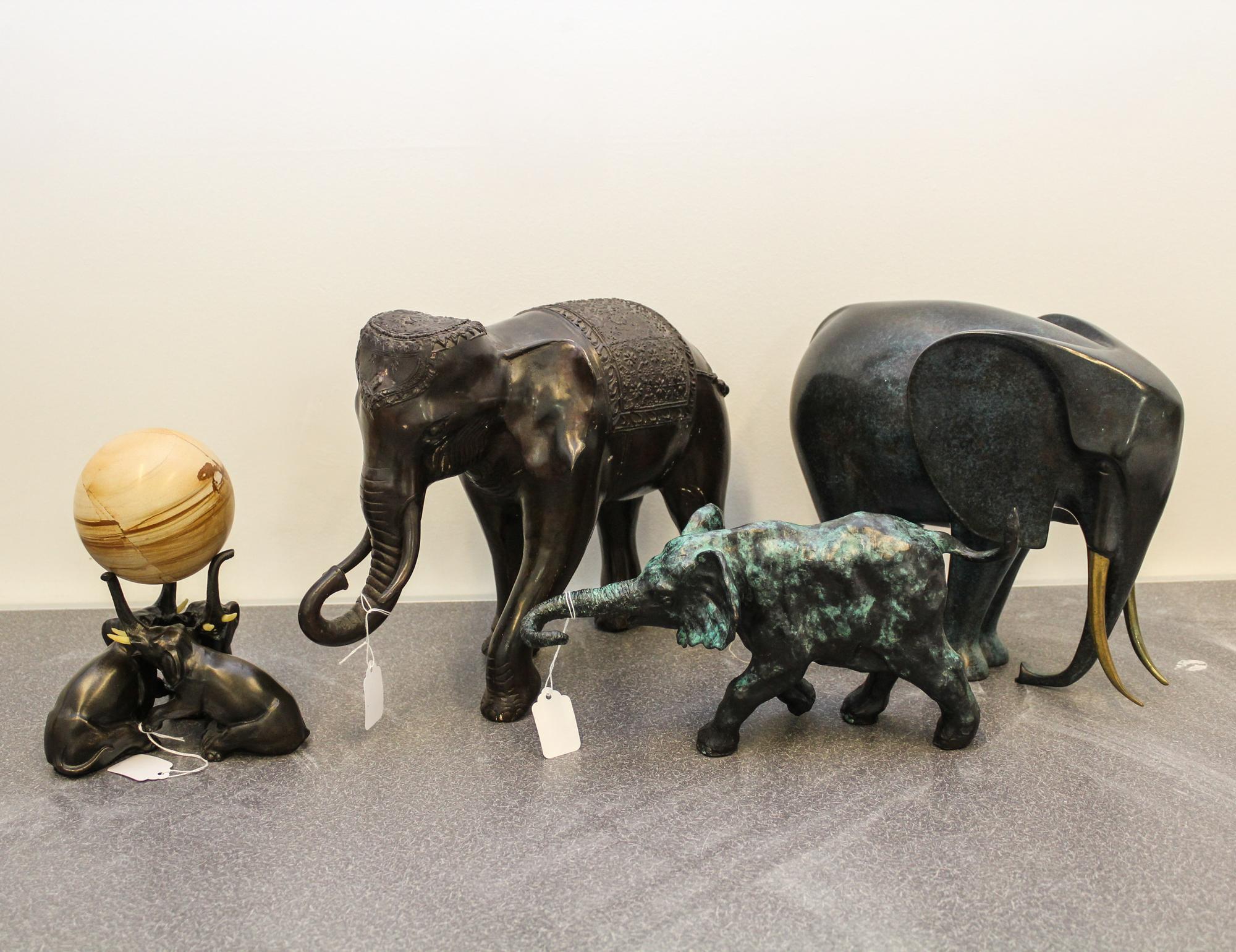 A Group of Four Cast Metal Elephant Figures Height of tallest 11 inches.