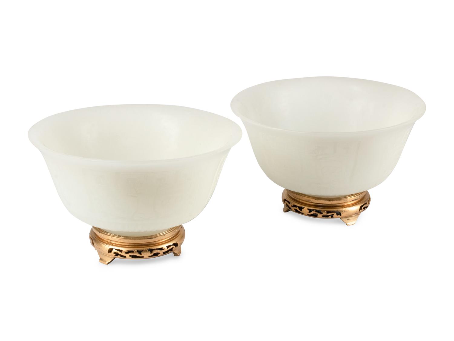 A Pair of Peking Style Carved White Glass Bowls with Wood Stands