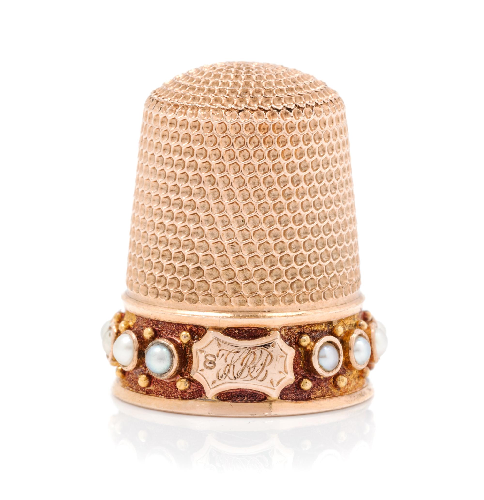 An American 14-Karat Rose Gold and Pearl Thimble, Simons Bros., Philadelphia, PA, the knurled top and body above a pearl inset band wit