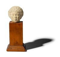 An Egyptian Limestone Head of a Nubian
