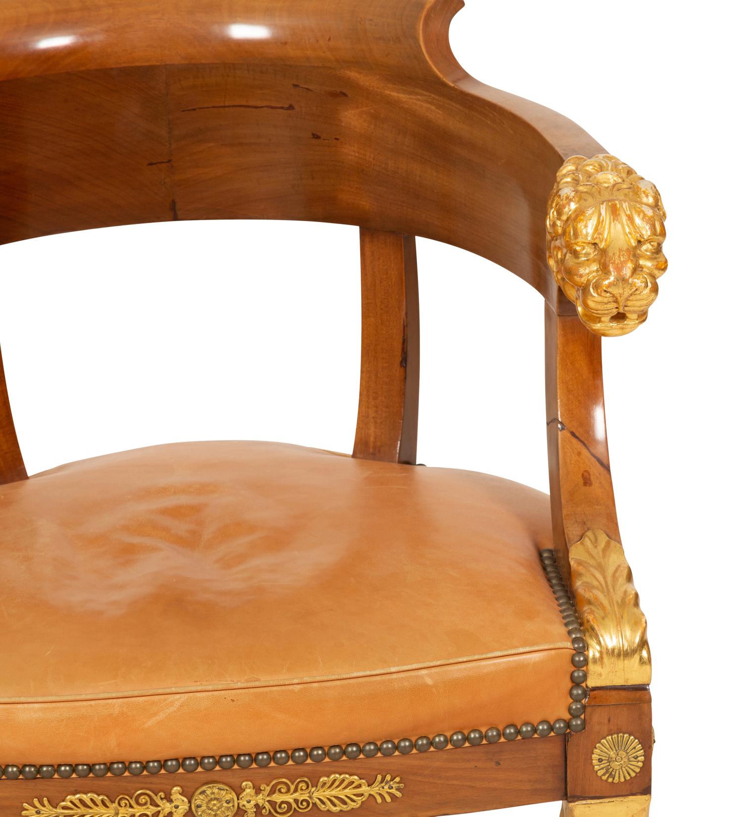 An Empire Gilt Bronze Mounted Mahogany and Parcel Gilt Fauteuil de Bureau