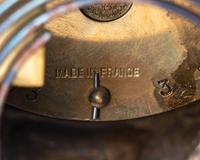 A French Cast Metal and Marble Figural Clock