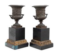A Pair of Continental Bronze Urns with Associated Plinths