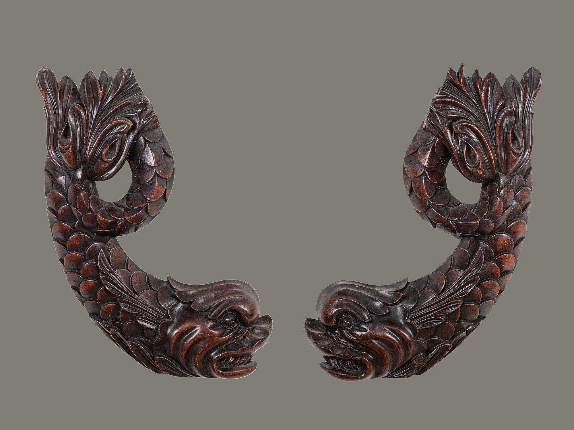 A Pair of Carved Mahogany Dolphin Brackets