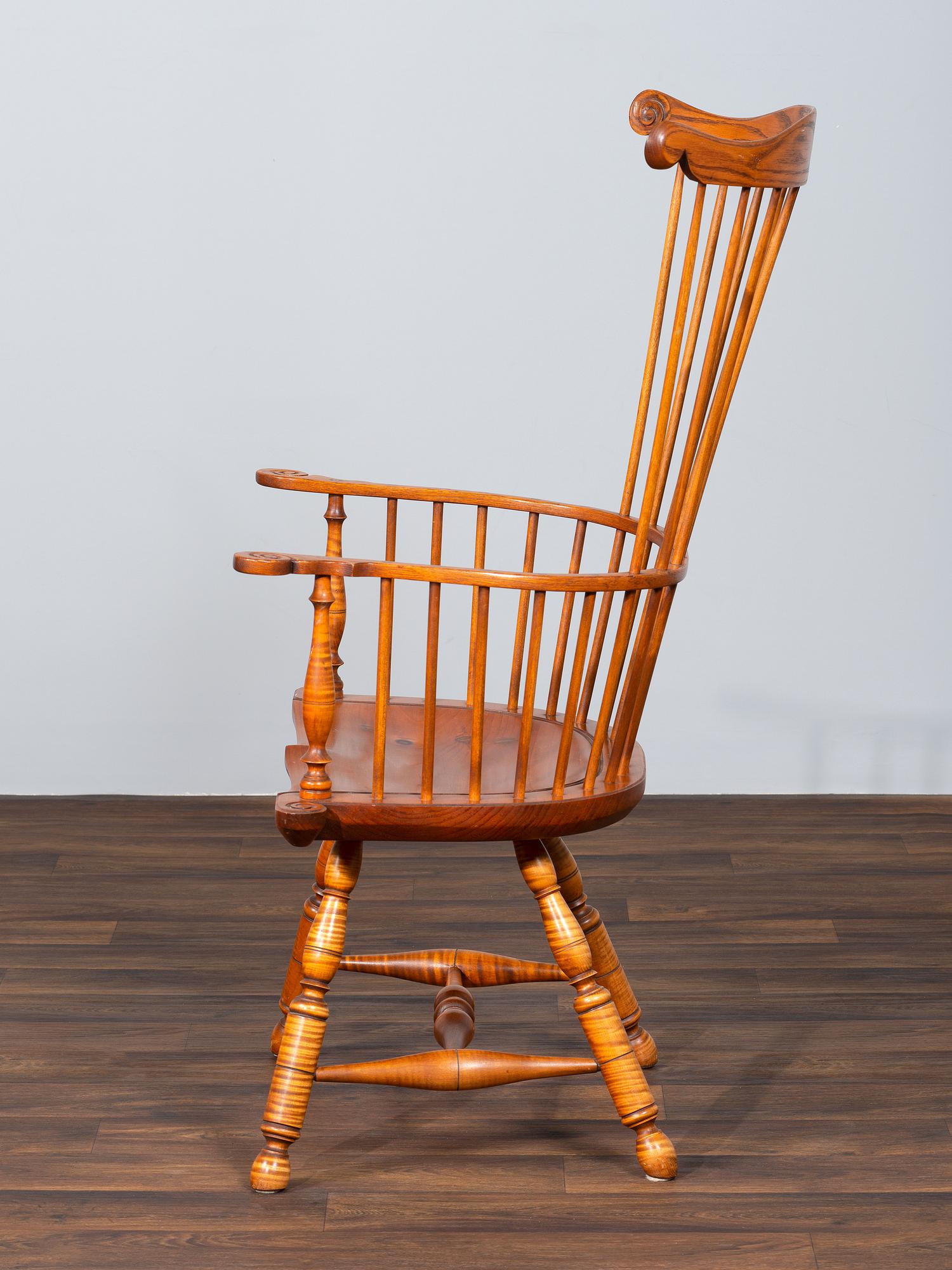 A D.R. Dimes Benchmark Turned and Volute Carved Tiger Maple and Pine Comb-Back Windsor Armchair