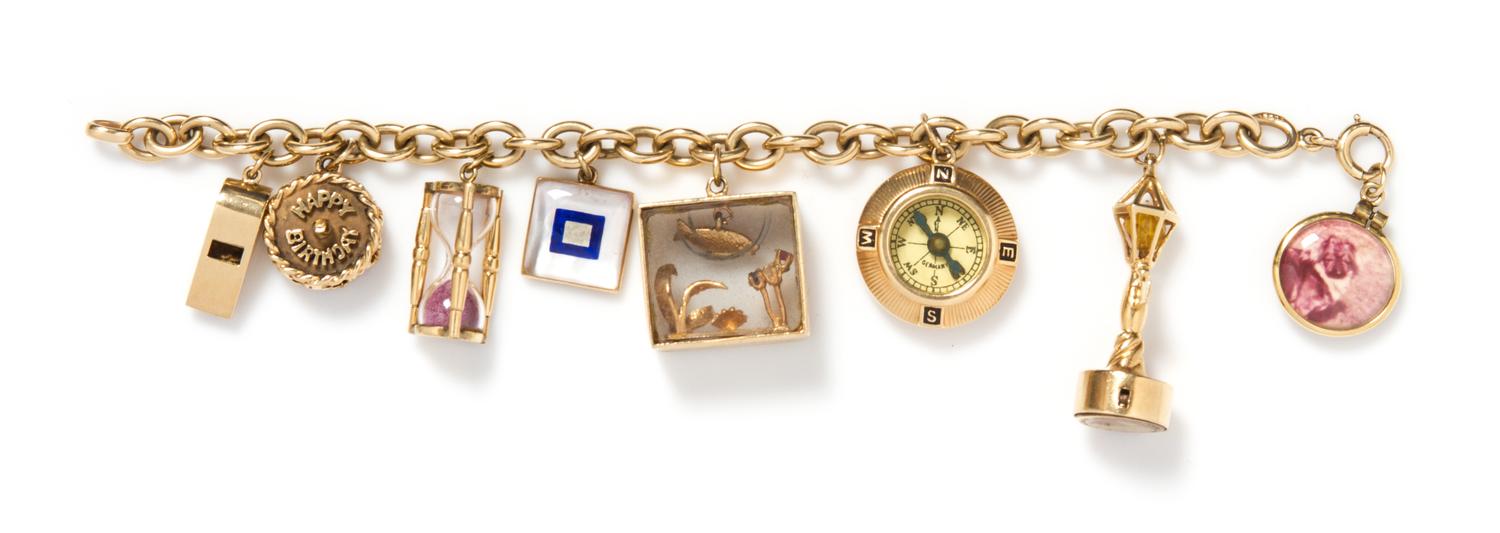 A 14 Karat Yellow Gold Charm Bracelet with Eight Attached Charms, 42.10 dwts.