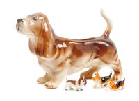 A Group of Four Basset Hound Ceramic Figures Width of widest 11 1/2 inches.