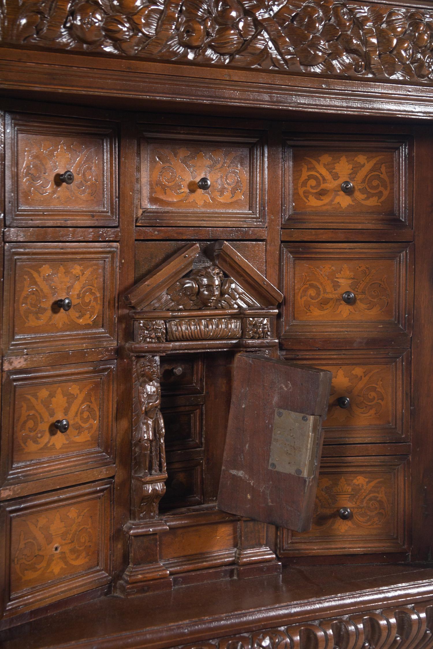 A Renaissance Revival Carved Walnut and Marquetry Collector's Cabinet