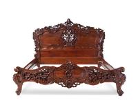 A Rococo Revival Carved Walnut Bed